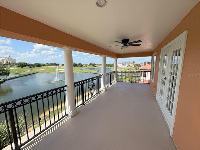 balcony with a water view and ceiling fan
