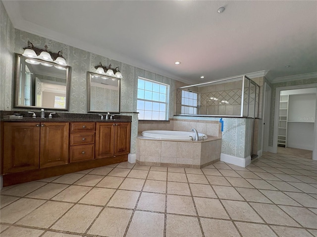 full bath featuring a shower stall, crown molding, a garden tub, and a sink