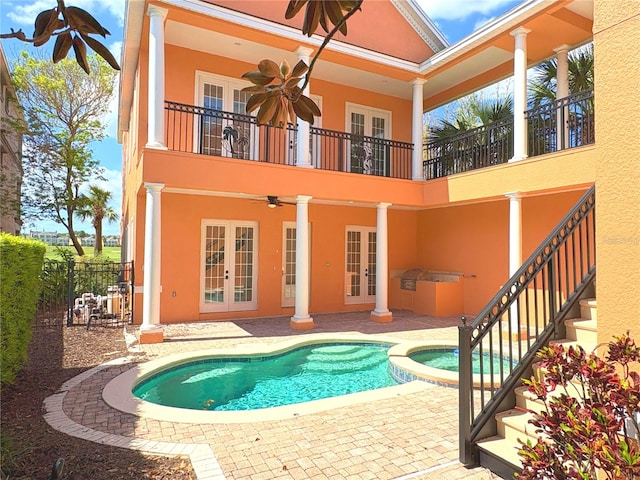1554 Corolla Ct, Reunion, FL 34747 - back of property featuring french doors, a balcony, stucco siding, and ceiling fan