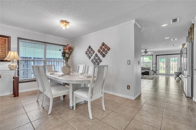 dining room with baseboards, french doors, visible vents, and ornamental molding