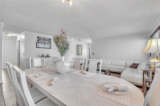 dining room featuring a textured ceiling and crown molding