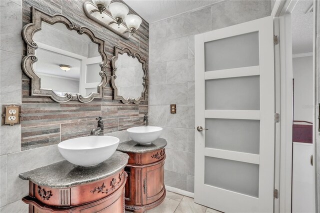 bathroom featuring tile patterned flooring, tile walls, and vanity
