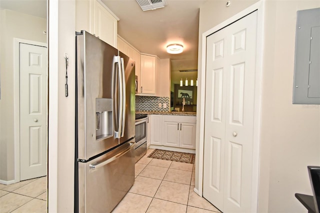 kitchen featuring light tile patterned flooring, visible vents, stainless steel appliances, and electric panel