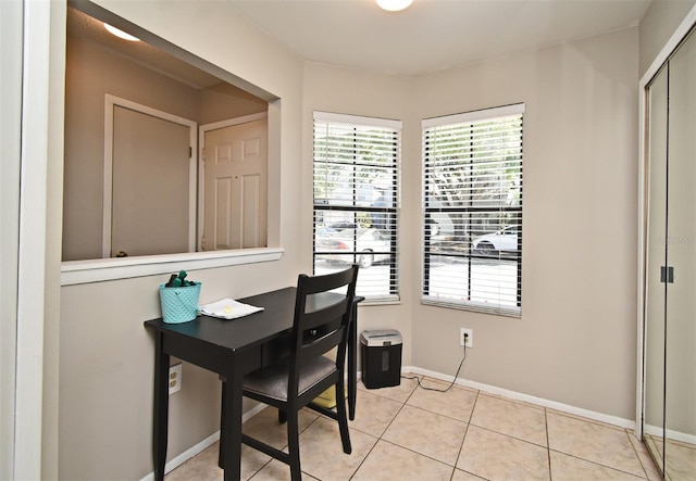 office area with light tile patterned flooring and baseboards