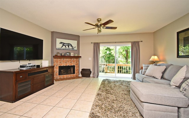 living room featuring a ceiling fan, light tile patterned floors, and a fireplace