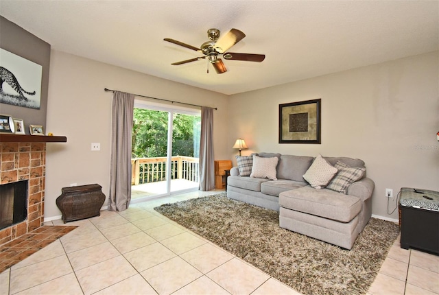 living area featuring baseboards, a fireplace, tile patterned flooring, and a ceiling fan