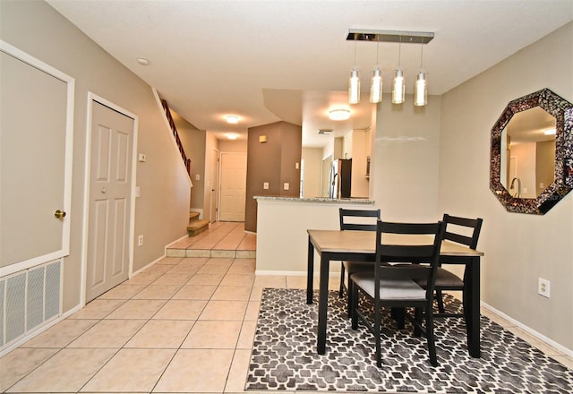 dining space with stairs, visible vents, baseboards, and light tile patterned floors