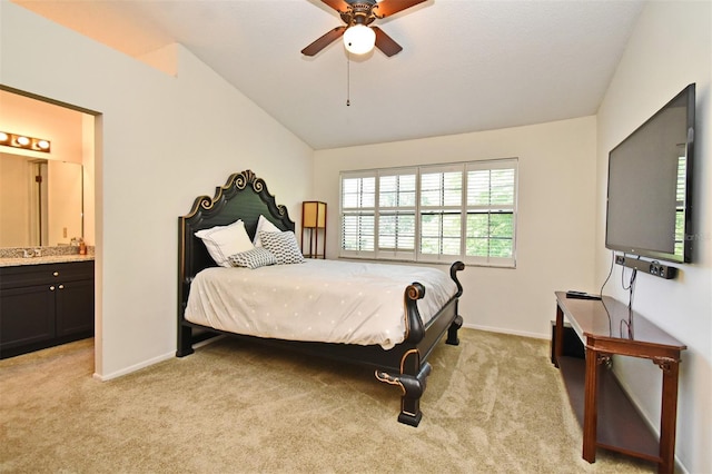 bedroom featuring ensuite bathroom, baseboards, ceiling fan, vaulted ceiling, and light colored carpet
