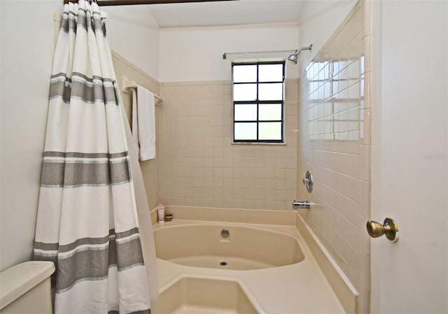 bathroom with toilet and shower / tub combo with curtain