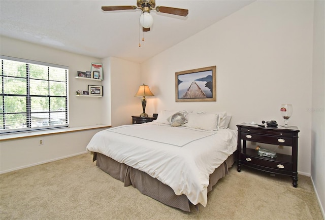 bedroom featuring baseboards, lofted ceiling, ceiling fan, and carpet