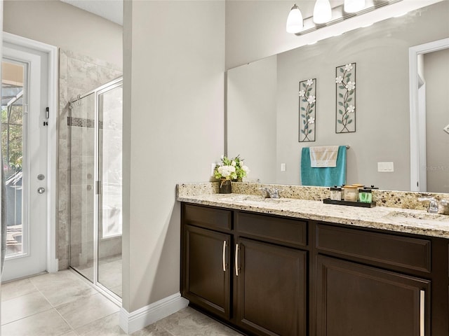 full bath featuring a sink, double vanity, and a stall shower