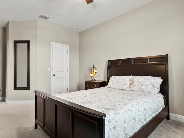 bedroom featuring ceiling fan, light carpet, visible vents, and baseboards
