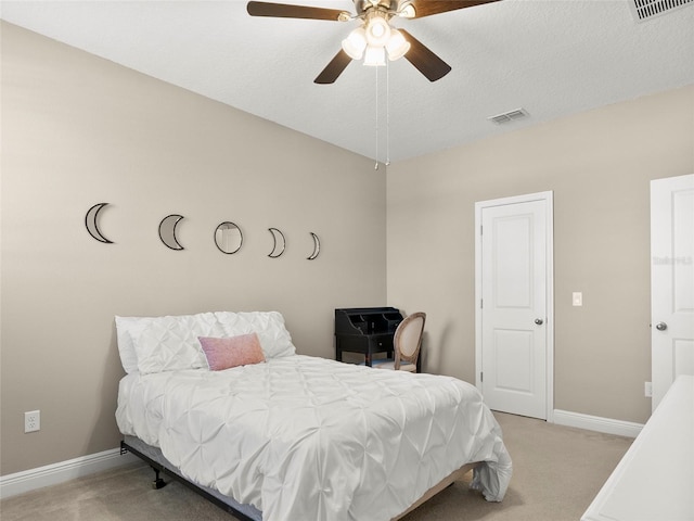bedroom featuring ceiling fan, visible vents, baseboards, and light carpet