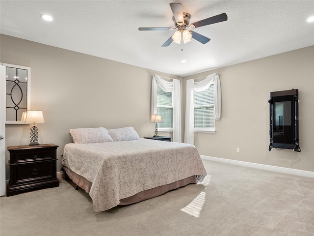 bedroom featuring baseboards, recessed lighting, and light colored carpet