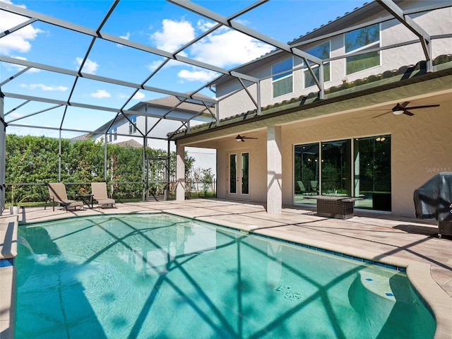 outdoor pool with glass enclosure, a ceiling fan, a patio, and a grill