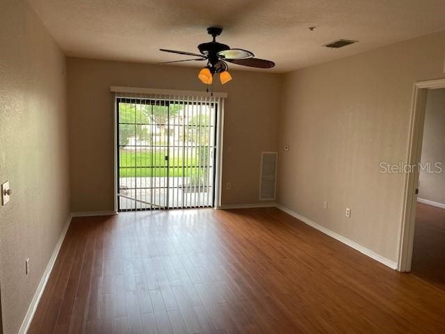 5550 E Michigan St Unit 2114, Orlando, FL 32822 - empty room featuring a textured ceiling, baseboards, wood finished floors, and a ceiling fan