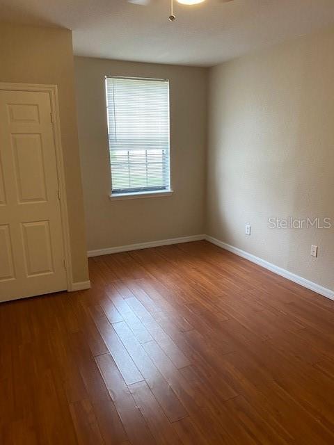 5550 E Michigan St Unit 2114, Orlando, FL 32822 - unfurnished room featuring baseboards and wood finished floors