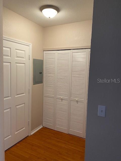 5550 E Michigan St Unit 2114, Orlando, FL 32822 - hallway featuring wood finished floors and electric panel