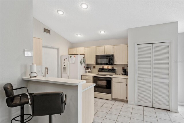 3830 Spring Breeze Dr, Orlando, FL 32829 - kitchen featuring light countertops, white refrigerator with ice dispenser, electric range oven, visible vents, and black microwave