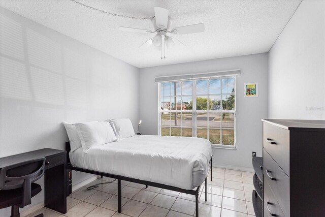3830 Spring Breeze Dr, Orlando, FL 32829 - bedroom with light tile patterned flooring, a ceiling fan, and a textured ceiling