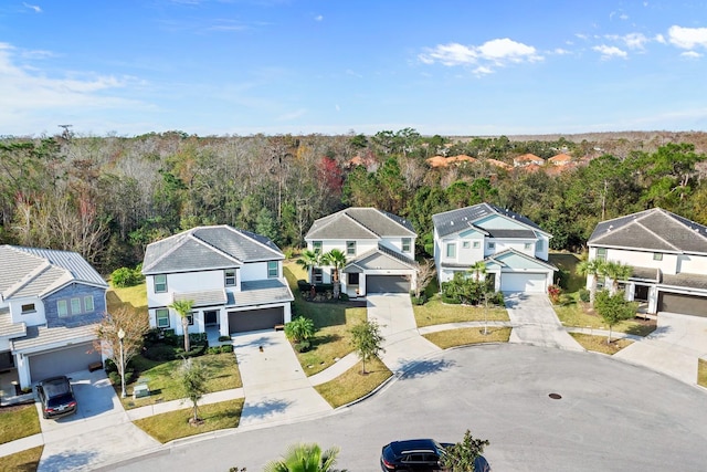 bird's eye view featuring a forest view and a residential view