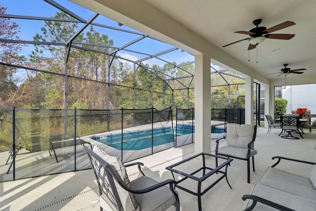 view of patio / terrace featuring an outdoor pool, glass enclosure, and ceiling fan