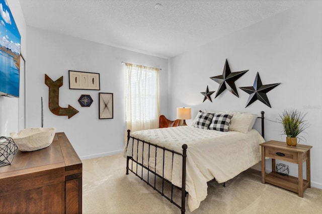 bedroom with light carpet, baseboards, and a textured ceiling