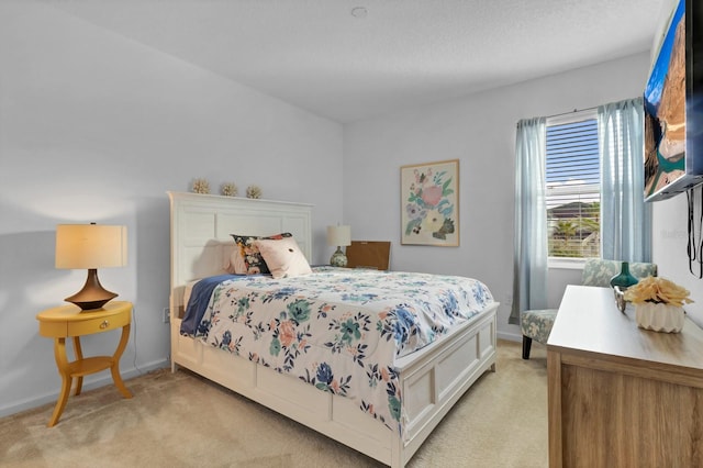 bedroom featuring light colored carpet and baseboards