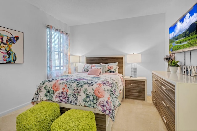 bedroom featuring baseboards and light carpet