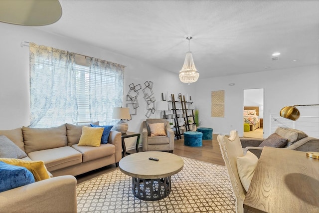 living area featuring wood finished floors and a chandelier