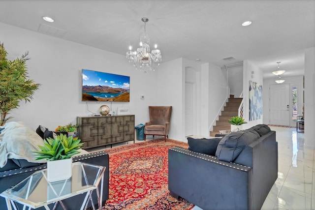 living area featuring marble finish floor, visible vents, stairway, and a notable chandelier