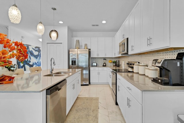 kitchen with visible vents, marble finish floor, appliances with stainless steel finishes, a sink, and backsplash