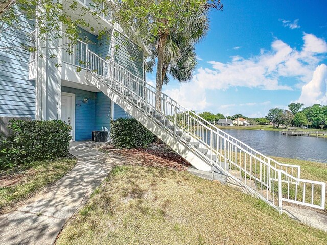 exterior space featuring a water view and stairs