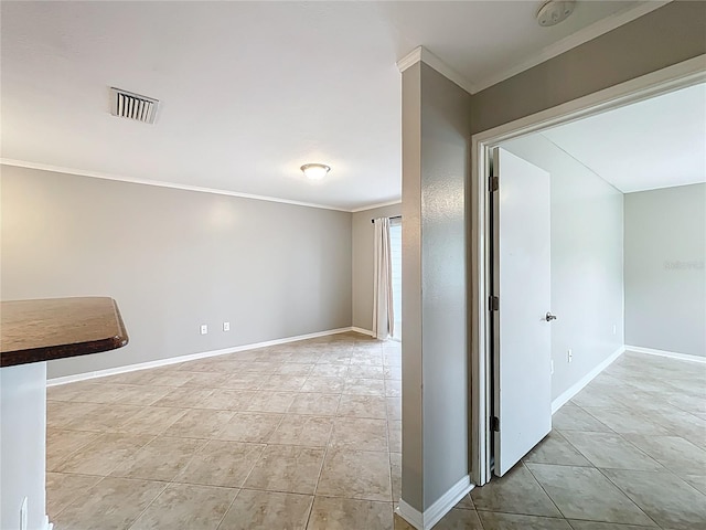 interior space with baseboards, ornamental molding, visible vents, and light tile patterned floors