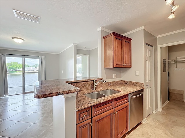 kitchen with light stone countertops, a sink, visible vents, dishwasher, and a peninsula