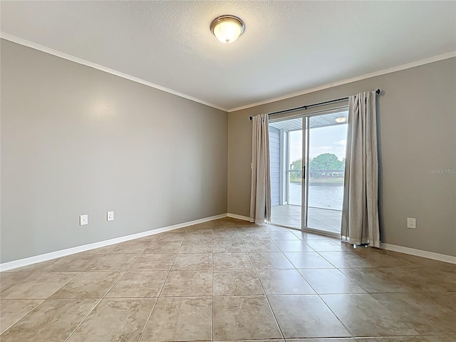 unfurnished room featuring baseboards, a textured ceiling, ornamental molding, and light tile patterned floors