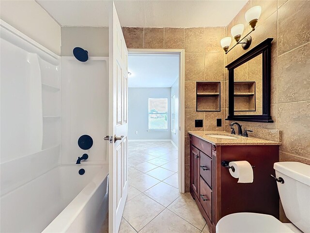 full bath with tile walls, tub / shower combination, toilet, tile patterned floors, and vanity