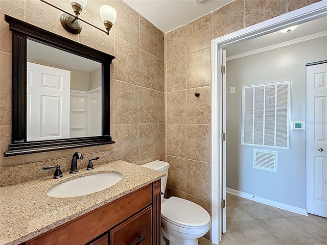 bathroom with tile walls, crown molding, toilet, tile patterned floors, and vanity