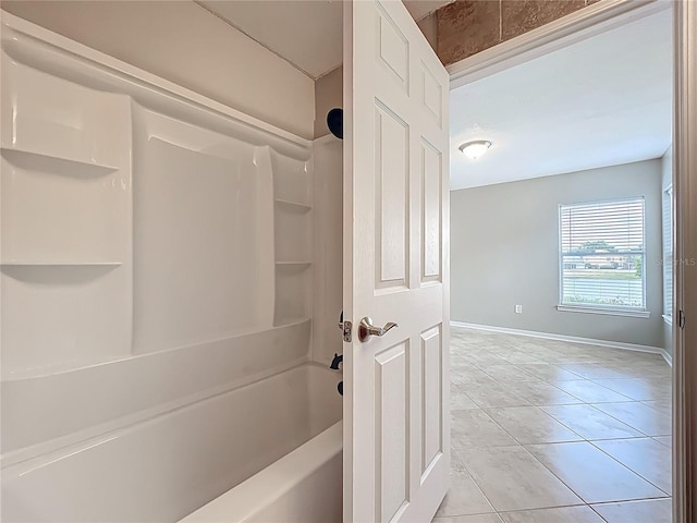 full bath featuring baseboards, tile patterned floors, and shower / bathtub combination