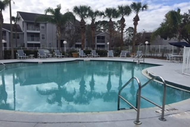 view of pool featuring a patio and fence