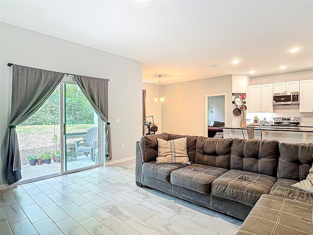 living area featuring recessed lighting and a notable chandelier