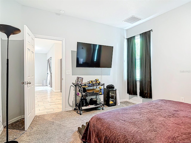bedroom featuring baseboards, visible vents, and carpet flooring