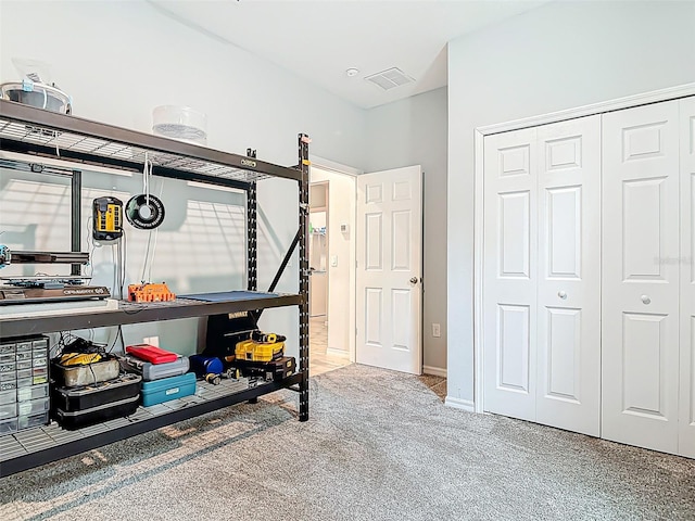 bedroom with visible vents, a closet, and carpet