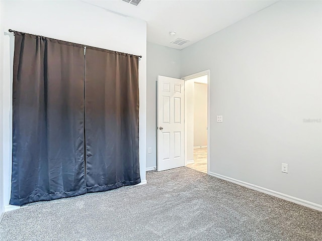 unfurnished bedroom with visible vents, baseboards, and carpet floors