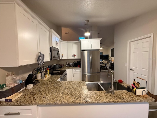 kitchen featuring white cabinets, visible vents, light stone countertops, and stainless steel appliances