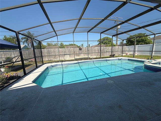 view of pool with a patio area, a fenced backyard, and glass enclosure