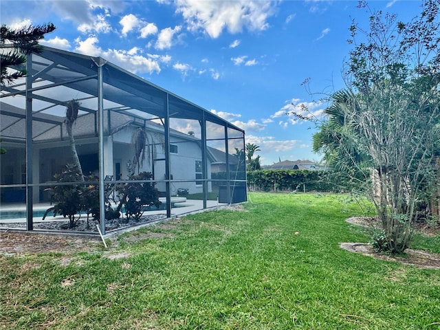view of yard with a lanai, an outdoor pool, and a patio area