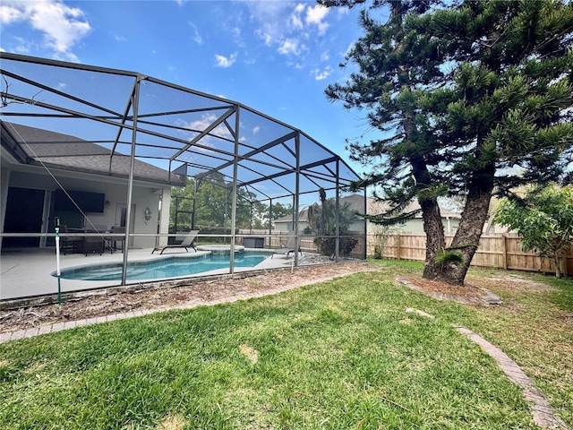 view of yard with a lanai, a fenced backyard, a fenced in pool, and a patio