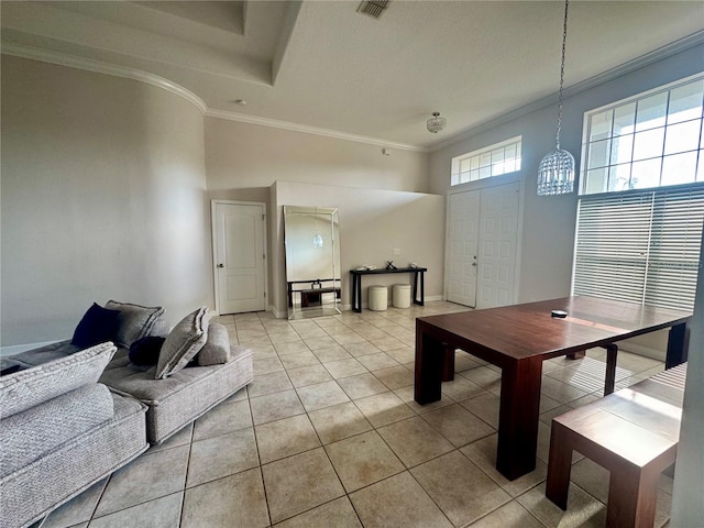 dining space featuring baseboards, crown molding, visible vents, and light tile patterned floors