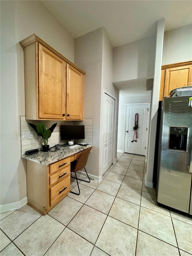 home office featuring built in study area, baseboards, and light tile patterned flooring